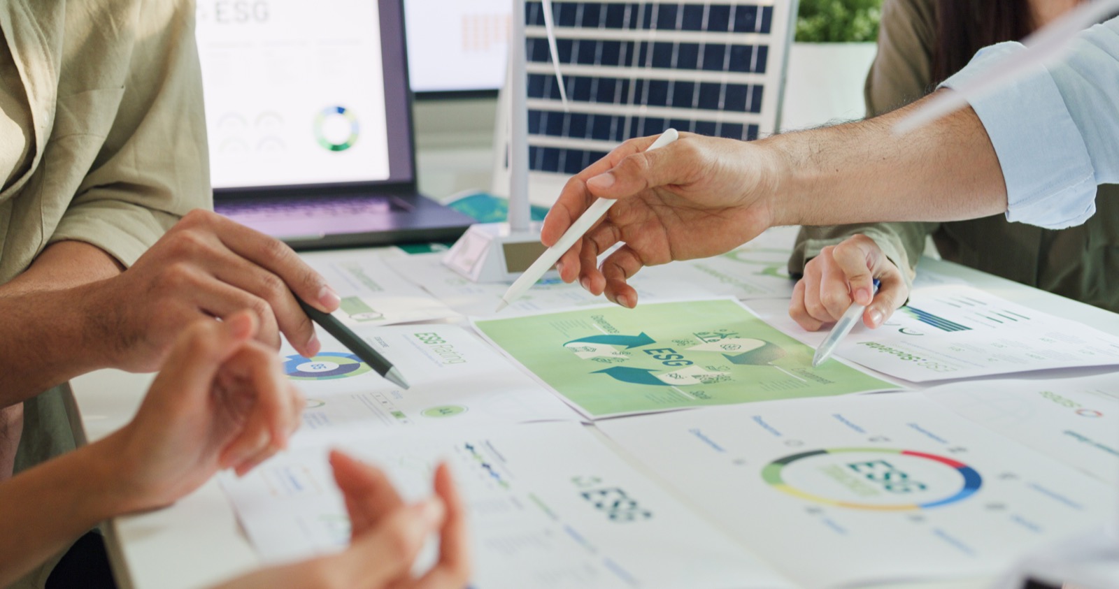 Consultants reviewing performance documents and charts